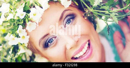 Attractive blond woman with colorful wreath on the head Stock Photo