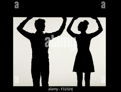 Strong couple holding the black ceiling Stock Photo