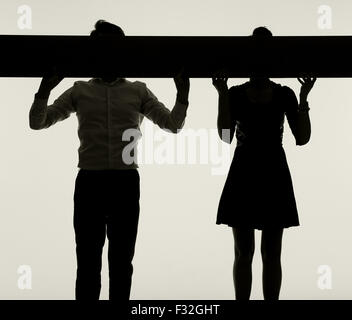 Young couple hiding faces behind the empty board Stock Photo
