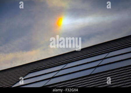 Chorley, Lancashire, UK. 28th September, 2015. UK Weather: Optical phenomena over roof with solar panel. The circumzenithal and circumhorizontal arcs are two related optical phenomena similar in appearance to a rainbow, but unlike the latter, their origin lies in light refraction through hexagonal ice crystals rather than liquid water droplets. This means that they are not rainbows, but members of the large family of halos. Credit:  Cernan Elias/Ģ����ý Live News Stock Photo