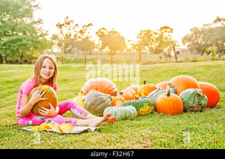 Girl by pumpkins and squash Stock Photo