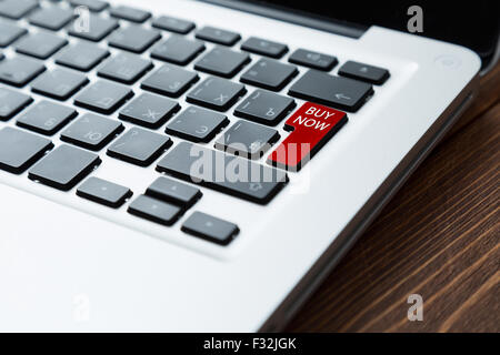 Red button buy now on a laptop Stock Photo