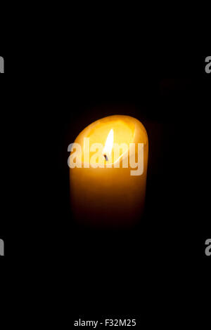 Church candle against a black background Stock Photo