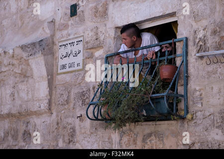 ISRAEL - JERUSALEM 28 SEPTEMBER: Palestinian residents looking at Israeli border police at an alley leading to the El Aksa mosque in the Muslim Quarter East Jerusalem Israel on 28 September 2015.  Israel has banned Muslim men under the age of 50 from worshipping at the Temple Mount compound but argues that it is about maintaining order. Stock Photo