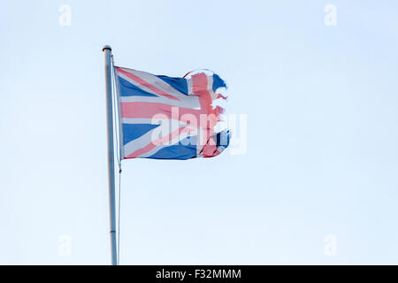 Ripped Union Jack. Torn UK flag in tatters suggesting a Brexit outcome or independence concept Stock Photo