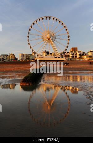 Brighton, UK. 28th September, 2015. UK Weather: The Brighton Wheel is reflected in the sand as an unusually low tide reveals the usually covered beach at sunset tonight after a warm sunny day of weather  Credit:  Simon Dack/Alamy Live News Stock Photo
