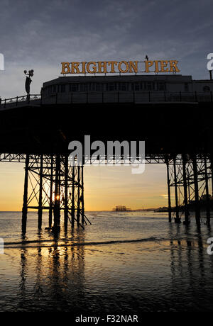 Brighton, UK. 28th September, 2015. UK Weather: People enjoy the unusually low tide at sunset on Brighton seafront tonight as the usually covered sand reveals itself along the coast after a warm sunny day of weather  Credit:  Simon Dack/Alamy Live News Stock Photo
