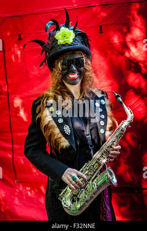 Beorma Border Morris dancer in costume with her saxophone Stock Photo