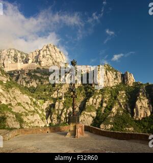 A colour image taken from the view from Saint Joans viewpoint at the Montserrat monastery of the rising sun lighting the view Stock Photo