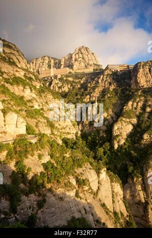A colour image taken from the view from Saint Joans viewpoint at the Montserrat monastery of the rising sun lighting the view Stock Photo