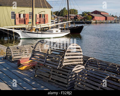 Historic Mystic Seaport Connecticut in autumn with lobster boxes traps tall ships Nellie and Regina M docked on the Mystic River Stock Photo