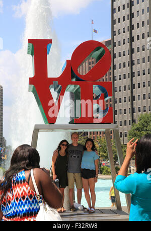Tourists photographing each other at the Love statue at JFK Plaza, in Philadelphia, Pennsylvania, USA Stock Photo