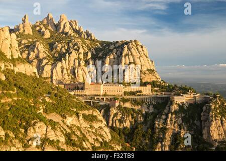 A colour image taken from the view from Saint Michaels viewpoint at the Montserrat monastery of the rising sun lighting the view Stock Photo