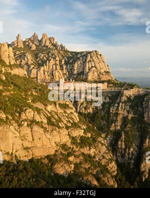 A colour image taken from the view from Saint Michaels viewpoint at the Montserrat monastery of the rising sun lighting the view Stock Photo