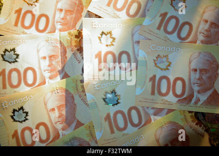 A collection of new Canadian 100 dollar bank note bills money Stock Photo