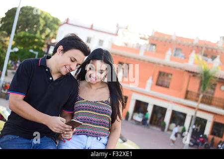 couple reading text messages in cartagena, colombia Stock Photo