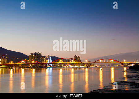 famous GuanDu Bridge shinning at night in Taipei,Taiwan Stock Photo