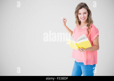 Composite image of hipster woman holding book Stock Photo
