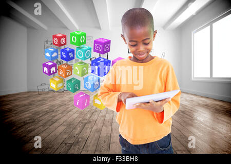 Composite image of cute boy using his tablet pc Stock Photo