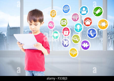 Composite image of cute boy using tablet Stock Photo