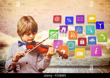 Composite image of cute little boy playing violin Stock Photo