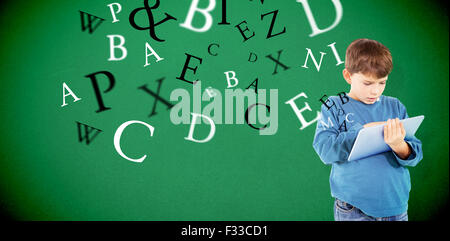 Composite image of cute boy using tablet Stock Photo