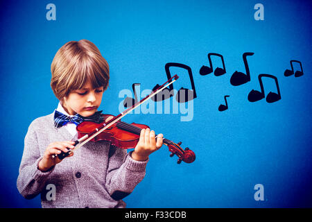 Composite image of cute little boy playing violin Stock Photo