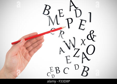 Composite image of hand holding red pencil Stock Photo