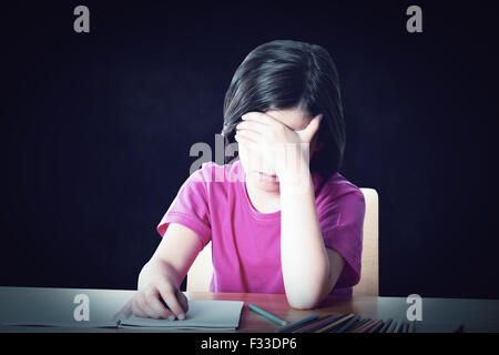 Composite image of cute pupil working at her desk Stock Photo - Alamy