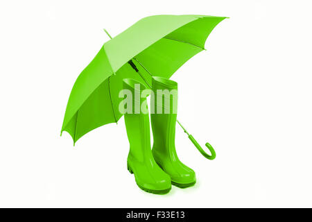 Rubber boots and umbreall isolated in green Stock Photo
