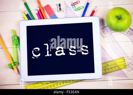 Class against students table with school supplies Stock Photo