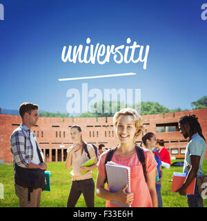 University against students using laptop in lawn against college building Stock Photo