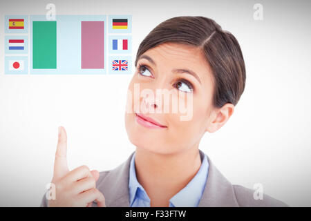 Composite image of close up of female entrepreneur pointing and looking up Stock Photo