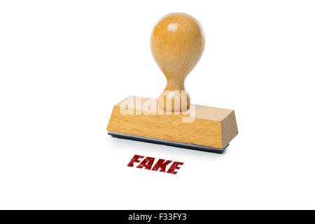 Fake printed in red ink with wooden Rubber stamp isolated on white background Stock Photo