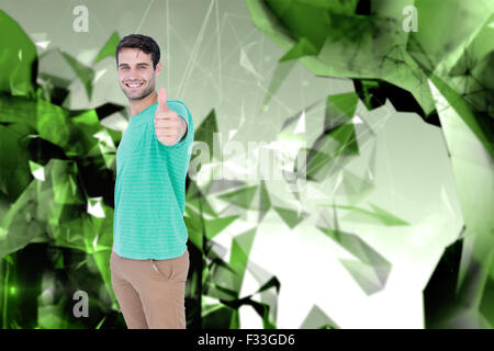 Composite image of portrait of smiling handsome man gesturing thumbs up Stock Photo