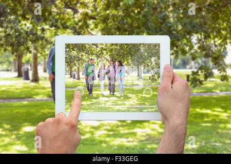 Composite image of hand holding tablet pc Stock Photo
