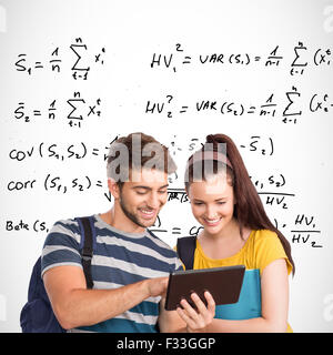Composite image of happy students using tablet pc Stock Photo