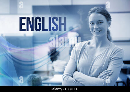 English against pretty teacher smiling at camera at back of classroom Stock Photo