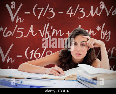Composite image of bored student doing her homework Stock Photo