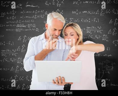 Composite image of mature students using laptop Stock Photo
