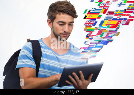 Composite image of male college student using digital tablet Stock Photo