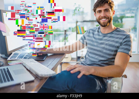 Composite image of  graphic designer using a graphics tablet Stock Photo