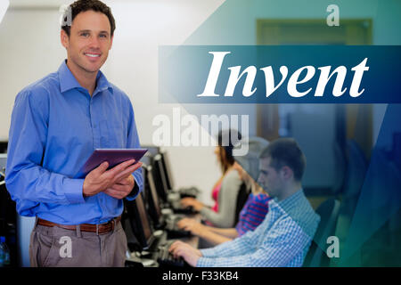 Invent against teacher with students using computers in computer room Stock Photo