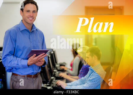 Plan against teacher with students using computers in computer room Stock Photo