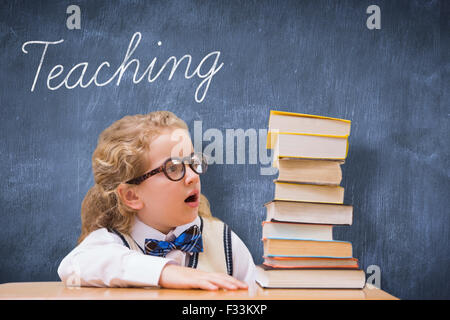 Teaching against blue chalkboard Stock Photo