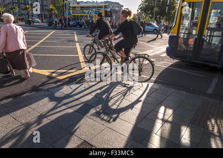 Cyclists and pedestrians on O'Connell Street in Dublin, Ireland Stock Photo