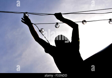 As the town basks in warm Autumnal sunshine Bolton Council put up their Christmas, lights. Stock Photo