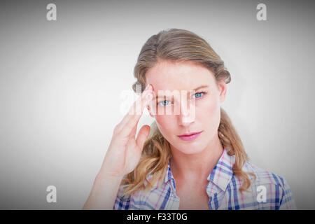 Composite image of pretty hipster with headache Stock Photo