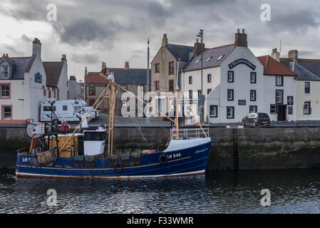 A Trawler at the quayside in Eyemouth Harbour Stock Photo