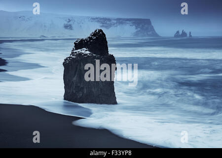 waves breaking on Reynisfjara with Reynisdranger beyond, Iceland Stock Photo